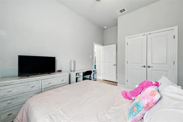 a bedroom with a bed and a flat screen tv