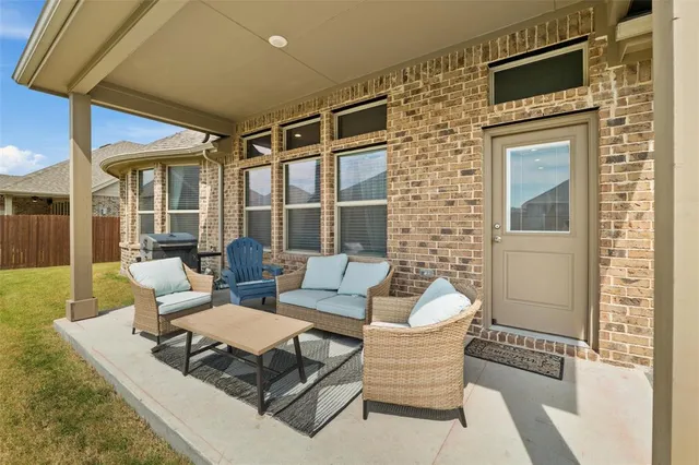 a outdoor space with patio the couches and a dining table with large windows