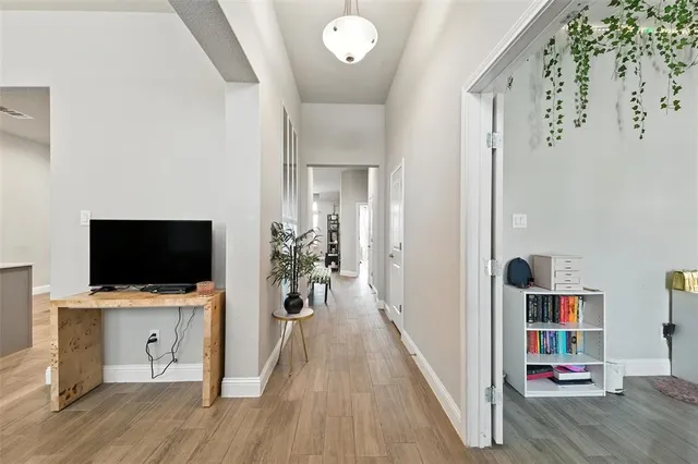 a view of a livingroom with wooden floor and a flat screen tv