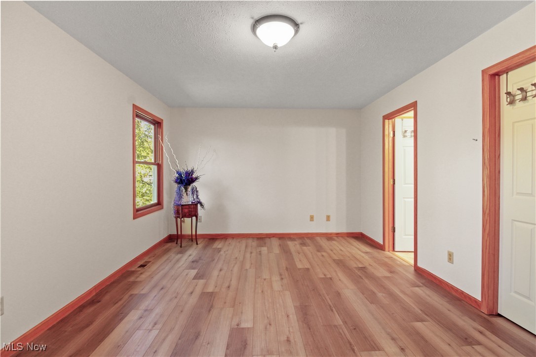 2632 Berry Road Akron, OH 44320 - Photo 20 of 39 Spare room featuring a textured ceiling and light hardwood / wood-style floors