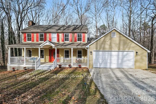 a view of a house with a yard and sitting area