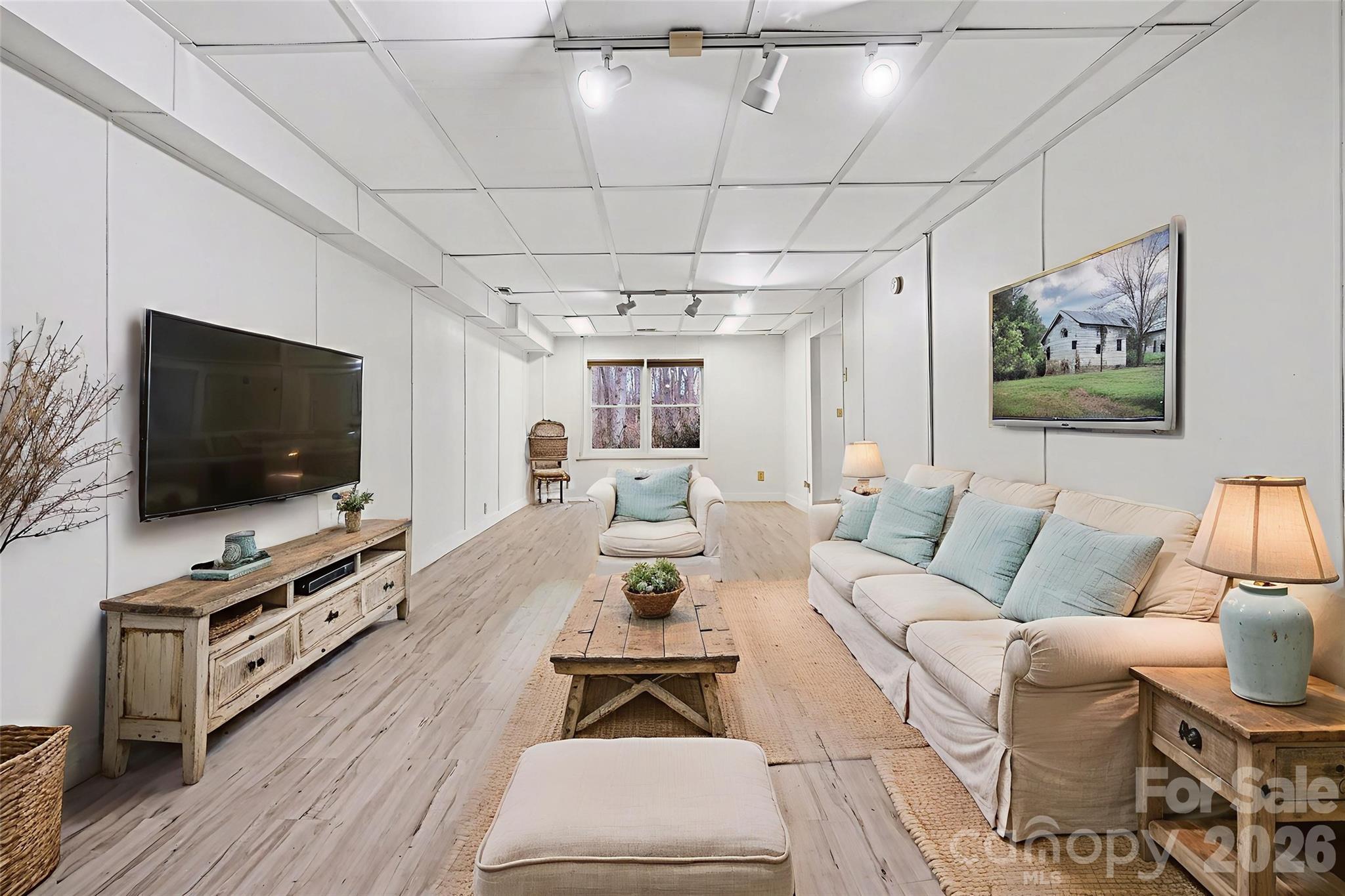 909 Woodland Forest Road Waxhaw, NC 28173 - Photo 12 of 38 a living room with furniture and a flat screen tv