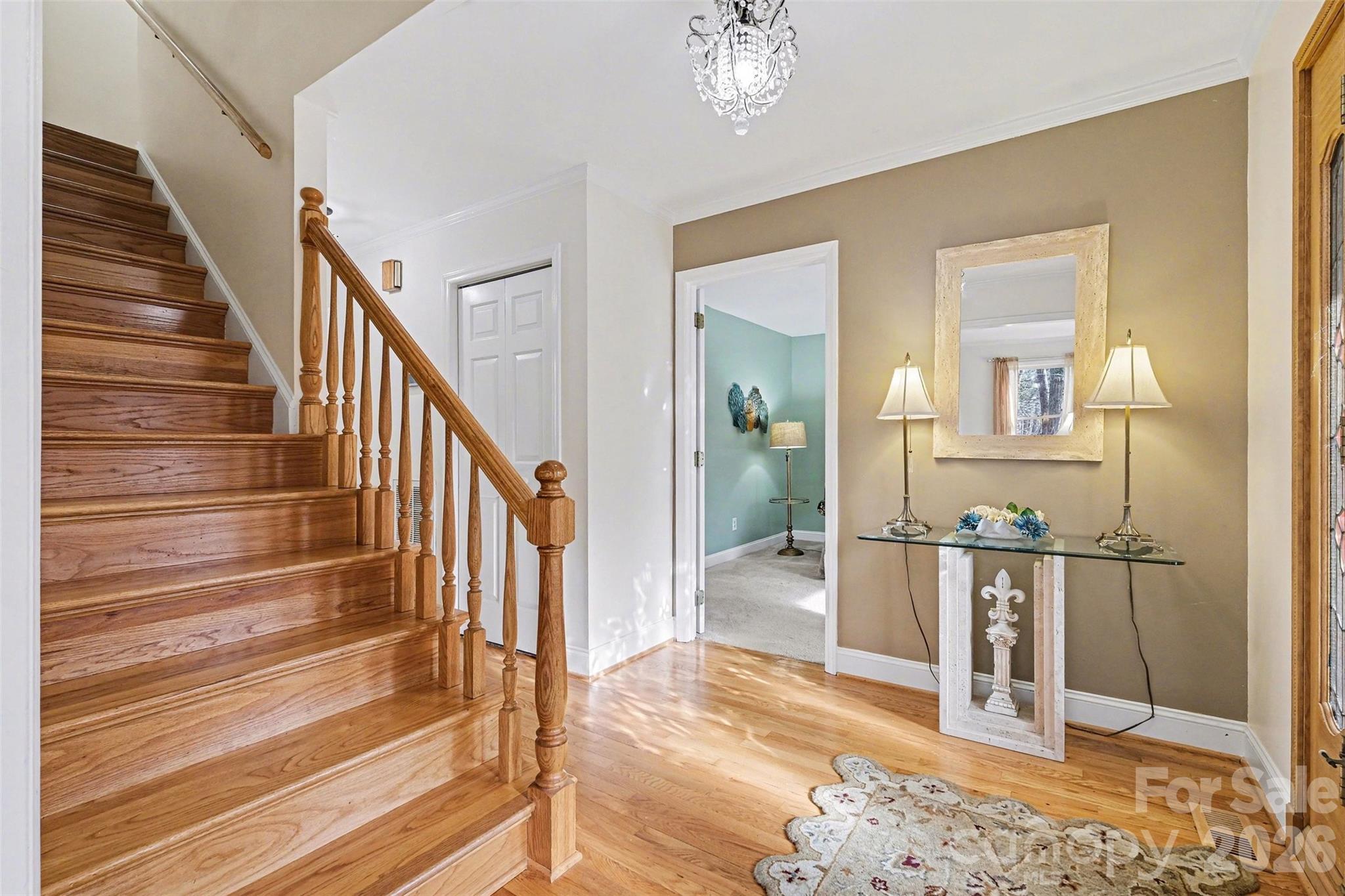 909 Woodland Forest Road Waxhaw, NC 28173 - Photo 21 of 38 a view of a hallway with wooden floor and stairs