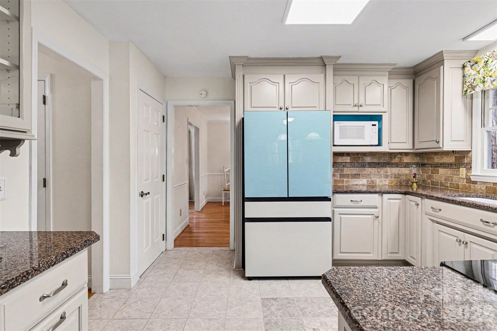 909 Woodland Forest Road Waxhaw, NC 28173 - Photo 27 of 38 a kitchen with a refrigerator sink and cabinets