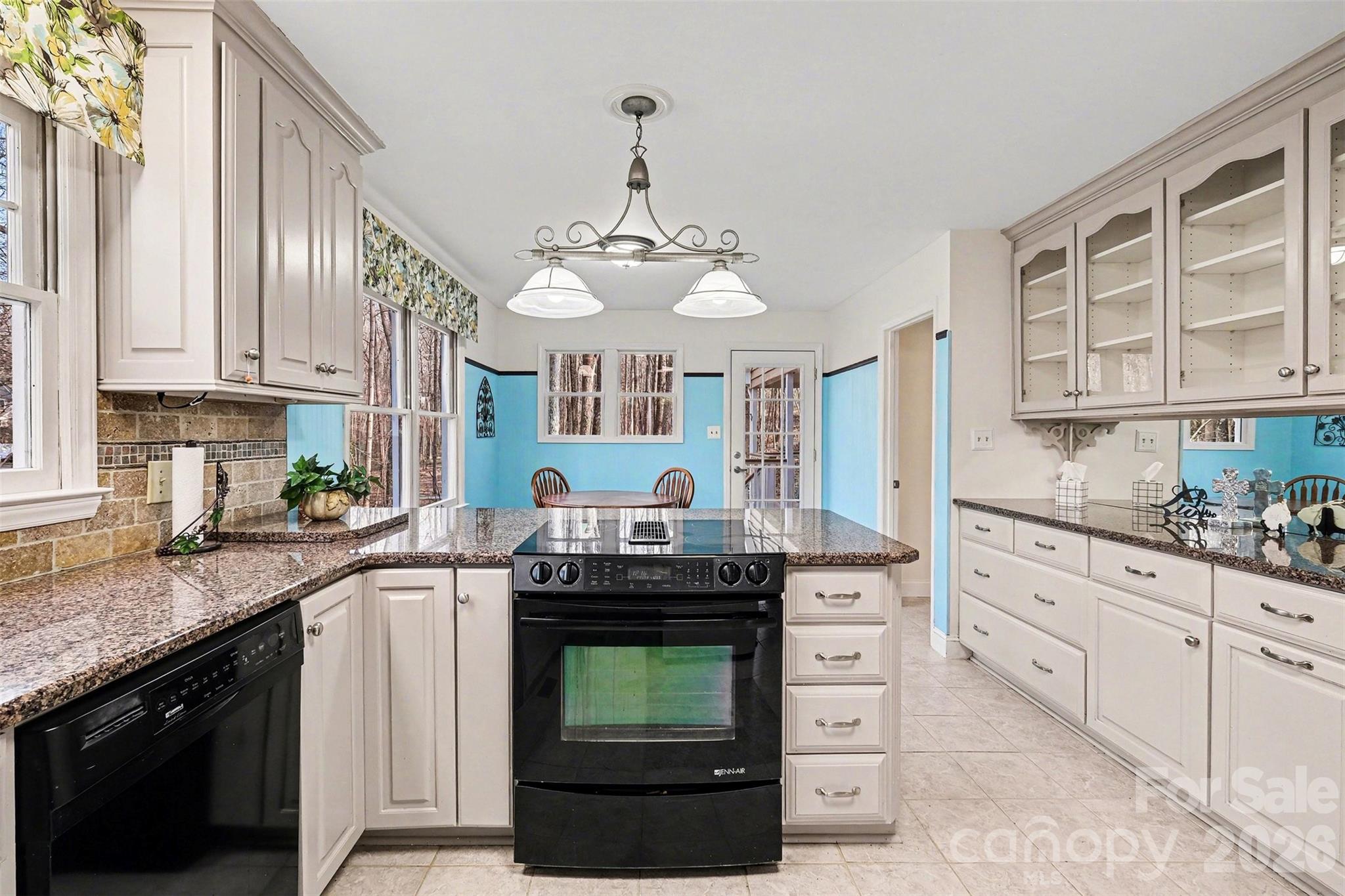 909 Woodland Forest Road Waxhaw, NC 28173 - Photo 28 of 38 a kitchen with granite countertop a stove and a sink