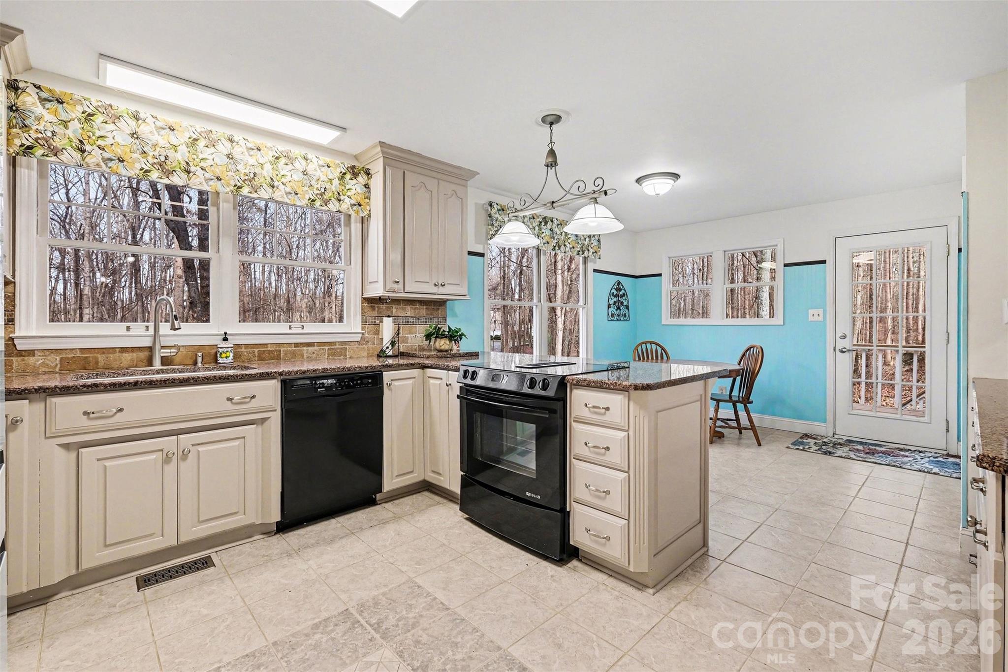 909 Woodland Forest Road Waxhaw, NC 28173 - Photo 29 of 38 a kitchen with a sink stove and cabinets