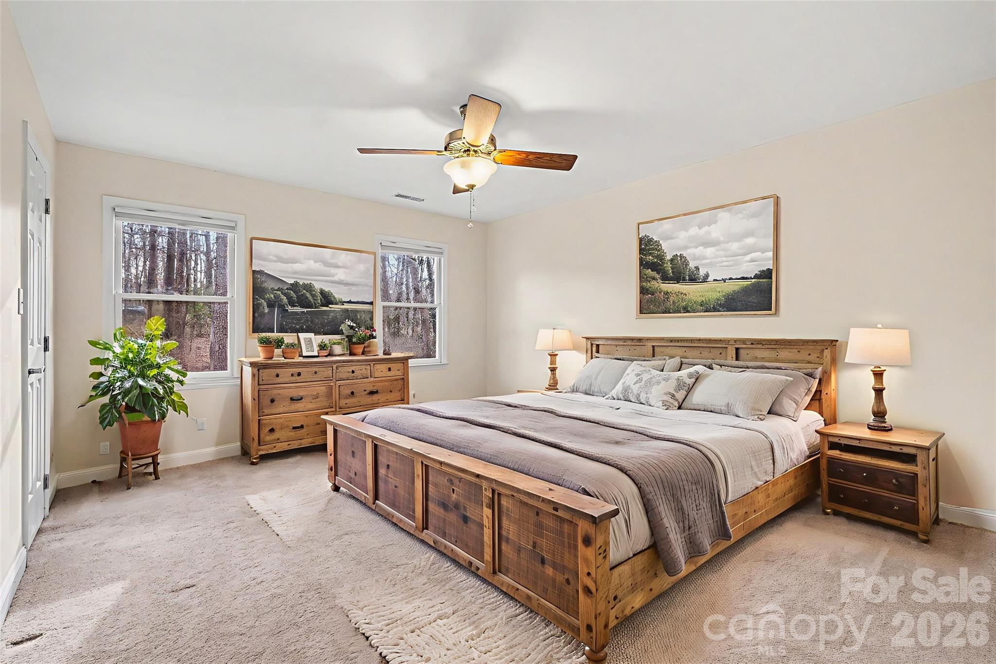 909 Woodland Forest Road Waxhaw, NC 28173 - Photo 7 of 38 a spacious bedroom with a bed a window and potted plant