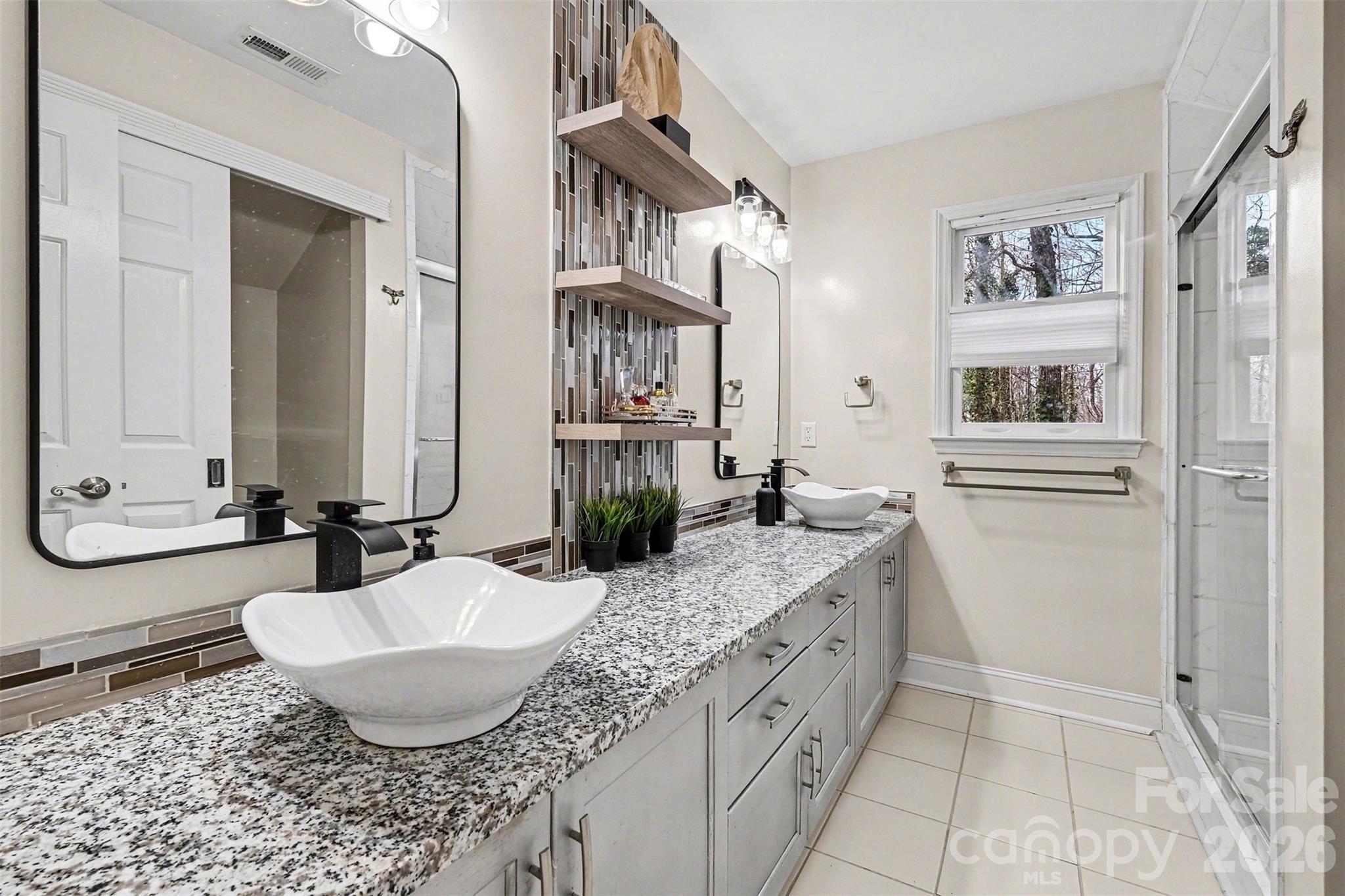 909 Woodland Forest Road Waxhaw, NC 28173 - Photo 8 of 38 a bathroom with a granite countertop sink and a mirror