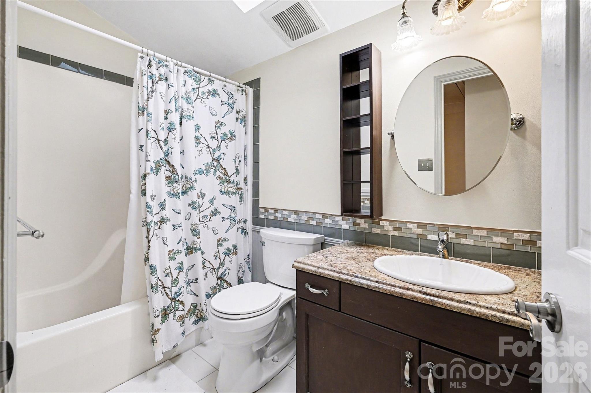909 Woodland Forest Road Waxhaw, NC 28173 - Photo 10 of 38 a bathroom with a granite countertop sink toilet and shower