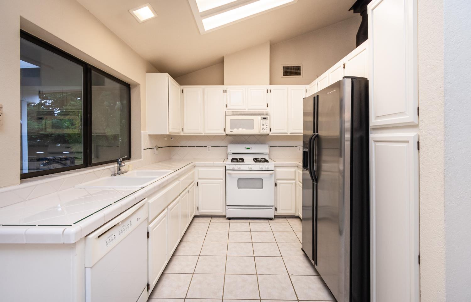 5705 Tudor Way Loomis, CA 95650 - Photo 19 of 59 a kitchen with a sink cabinets and stainless steel appliances