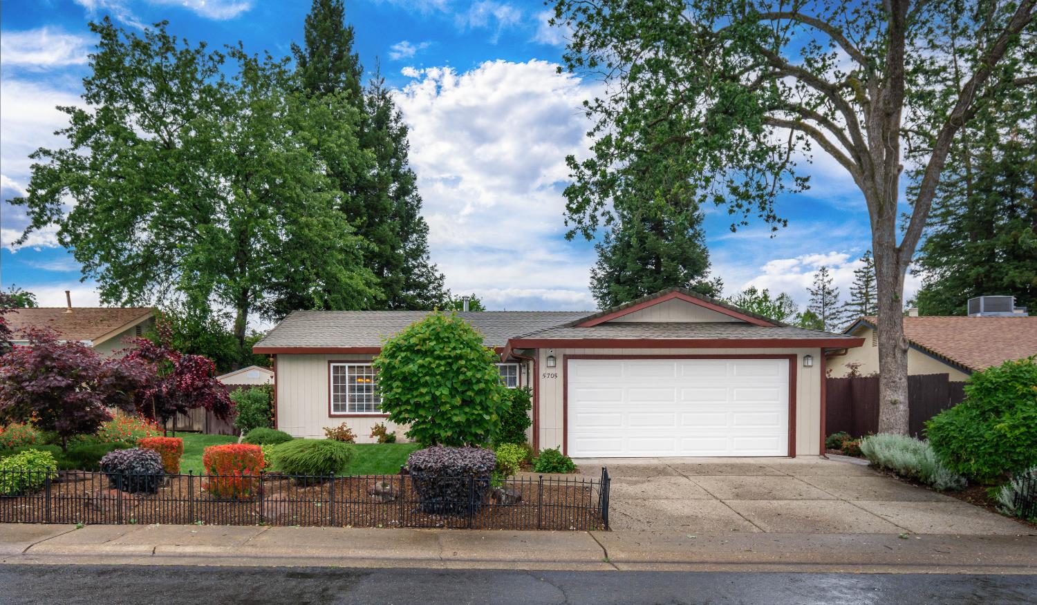 5705 Tudor Way Loomis, CA 95650 - Photo 2 of 59 a front view of a house with a garden and garage
