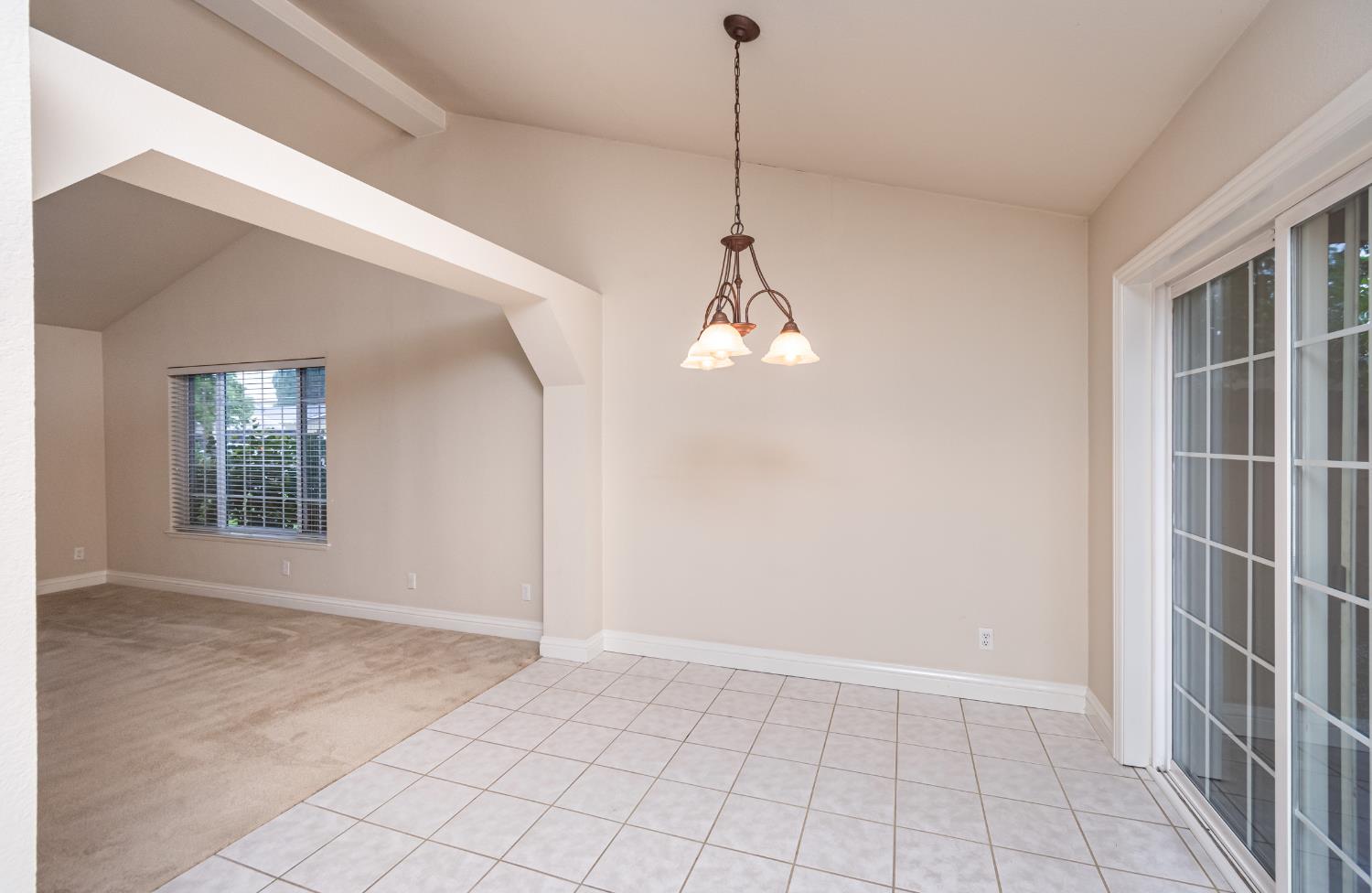 5705 Tudor Way Loomis, CA 95650 - Photo 21 of 59 a view of empty room with windows and chandelier