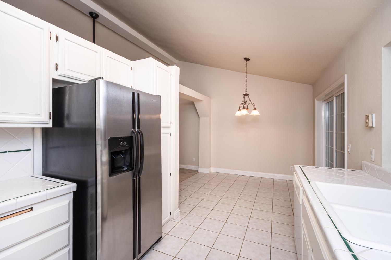 5705 Tudor Way Loomis, CA 95650 - Photo 22 of 59 a kitchen with kitchen island a counter top space appliances and cabinets