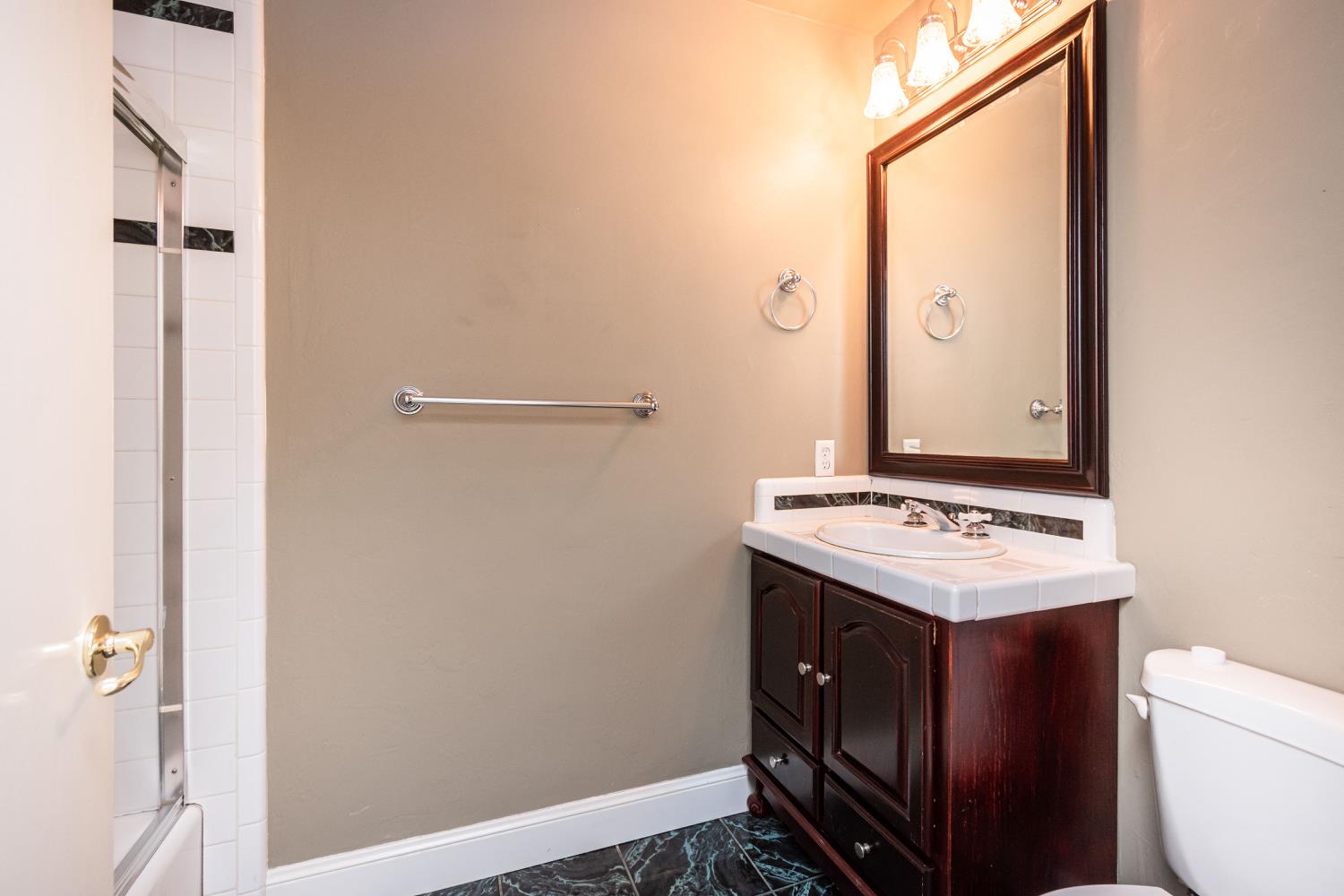 5705 Tudor Way Loomis, CA 95650 - Photo 24 of 59 a bathroom with a sink and a mirror