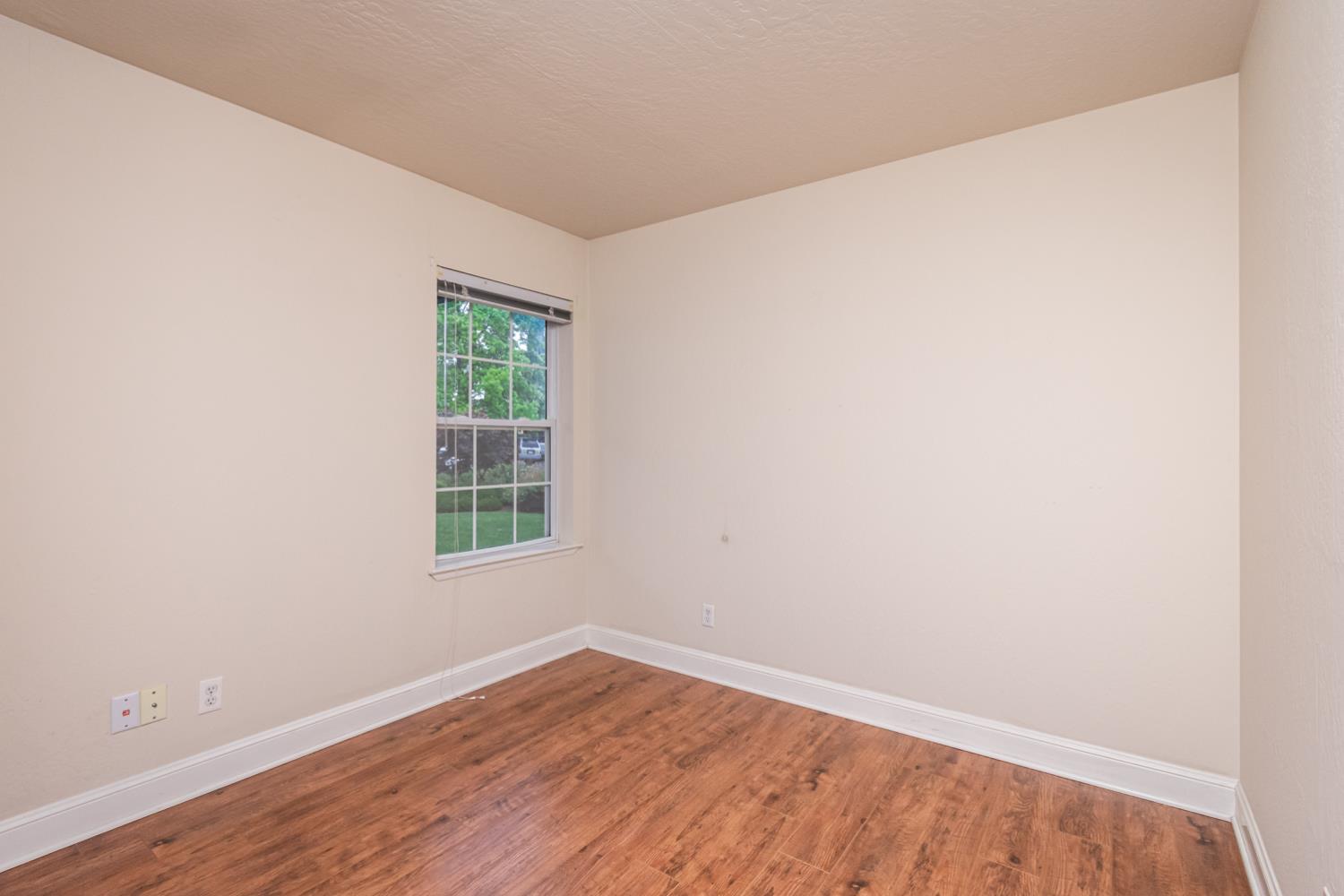 5705 Tudor Way Loomis, CA 95650 - Photo 26 of 59 an empty room with wooden floor and windows
