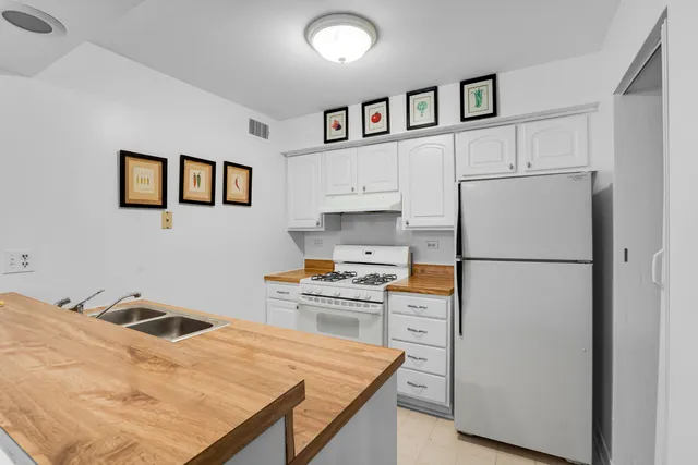 a kitchen with stainless steel appliances refrigerator and stove