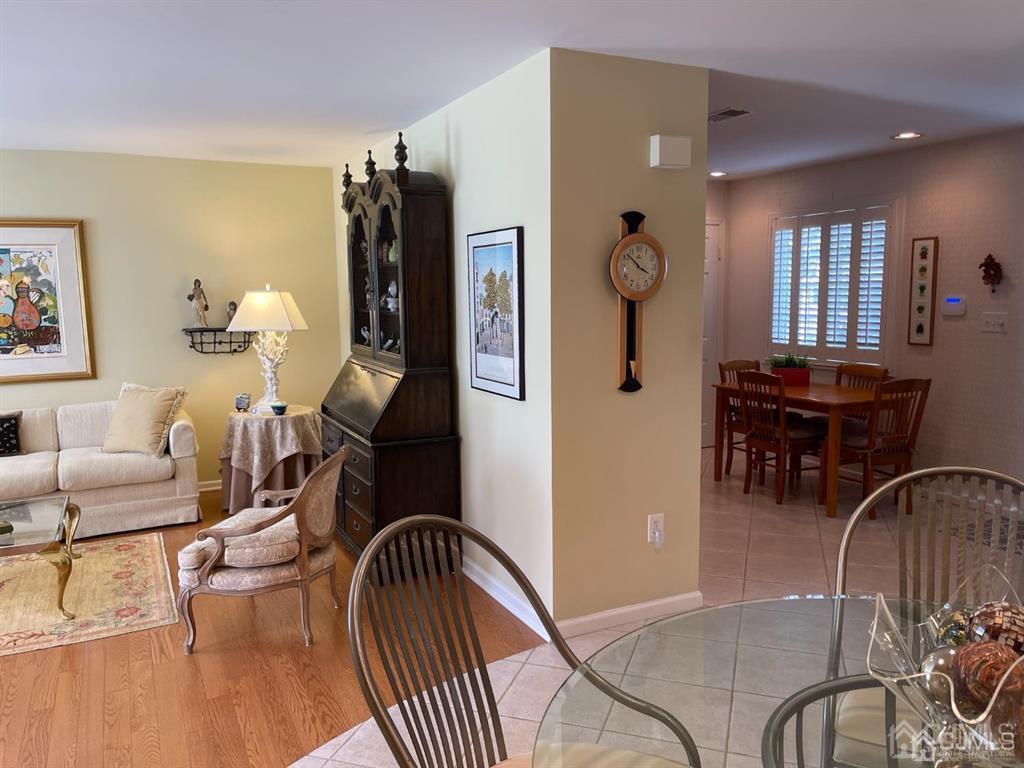 70 A Winthrop Road Monroe Township, NJ 08831 - Photo 13 of 50 a living room with furniture a dining table and wooden floor