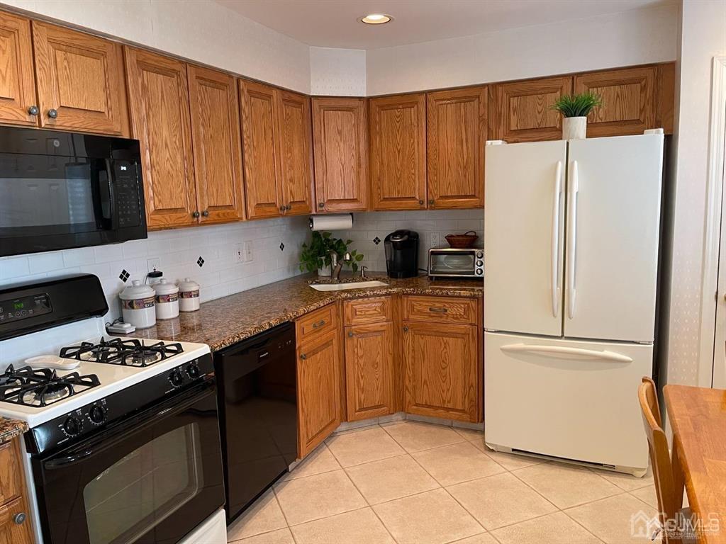 70 A Winthrop Road Monroe Township, NJ 08831 - Photo 16 of 50 a kitchen with a refrigerator stove and microwave