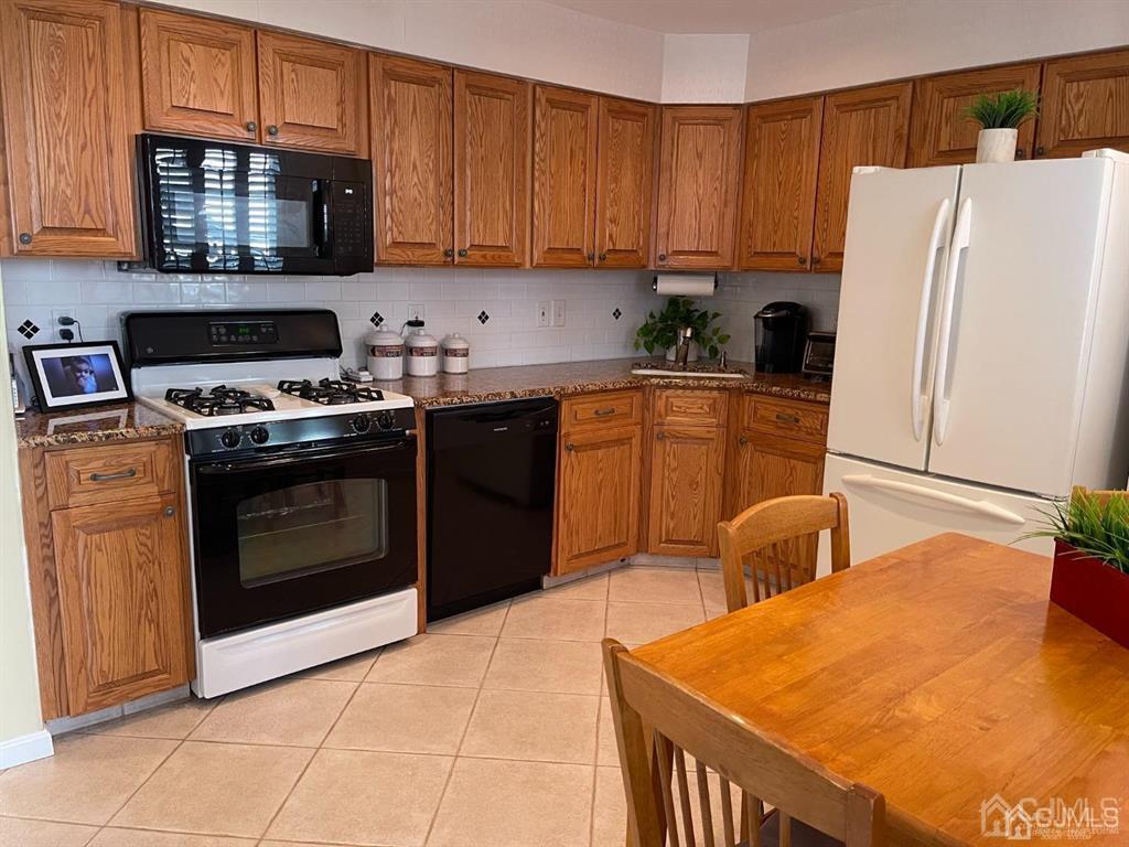 70 A Winthrop Road Monroe Township, NJ 08831 - Photo 18 of 50 a kitchen with stainless steel appliances granite countertop a stove a sink dishwasher and a refrigerator