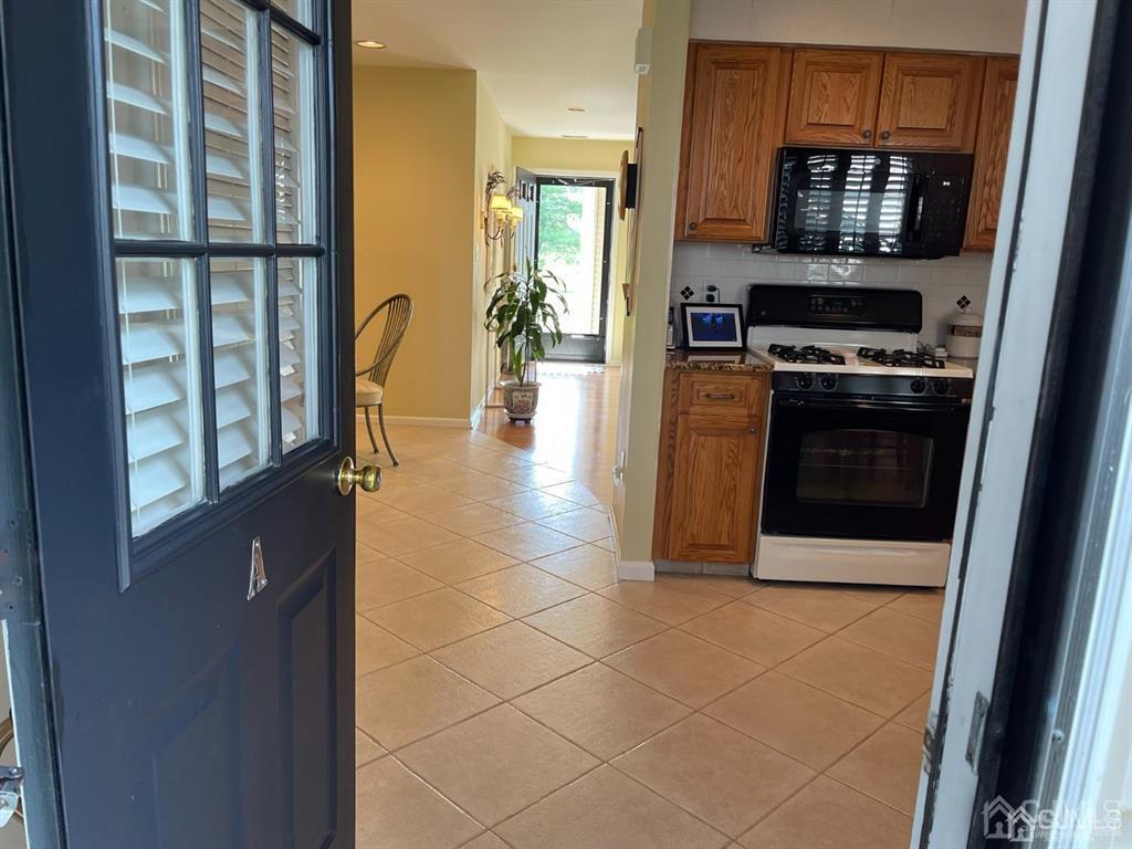 70 A Winthrop Road Monroe Township, NJ 08831 - Photo 20 of 50 a kitchen with stainless steel appliances a stove a microwave and a refrigerator