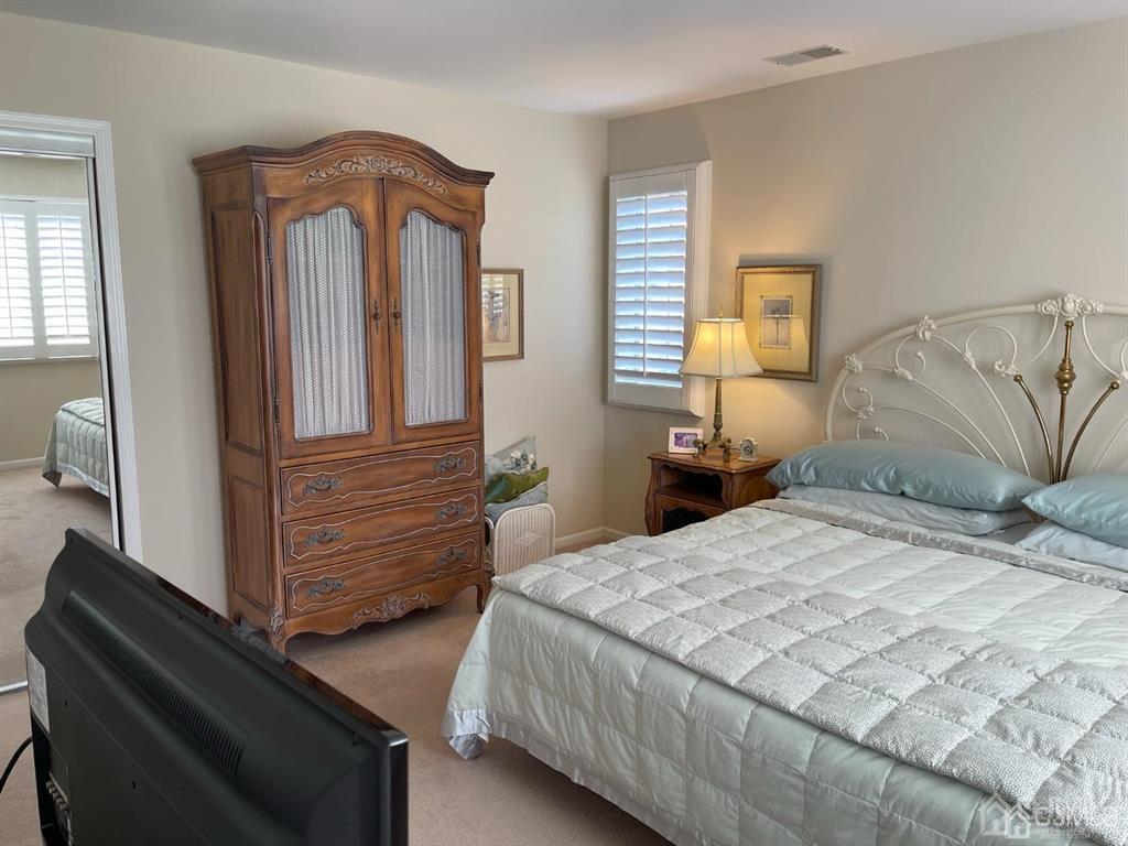 70 A Winthrop Road Monroe Township, NJ 08831 - Photo 25 of 50 a bedroom with a bed and a mirror on dresser