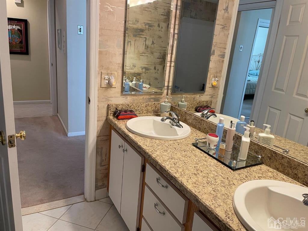 70 A Winthrop Road Monroe Township, NJ 08831 - Photo 30 of 50 a bathroom with a granite countertop sink and a mirror