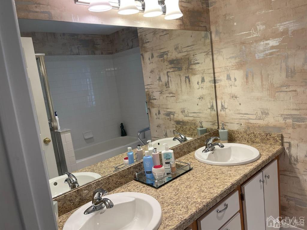 70 A Winthrop Road Monroe Township, NJ 08831 - Photo 35 of 50 a bathroom with a granite countertop sink a mirror and a shower