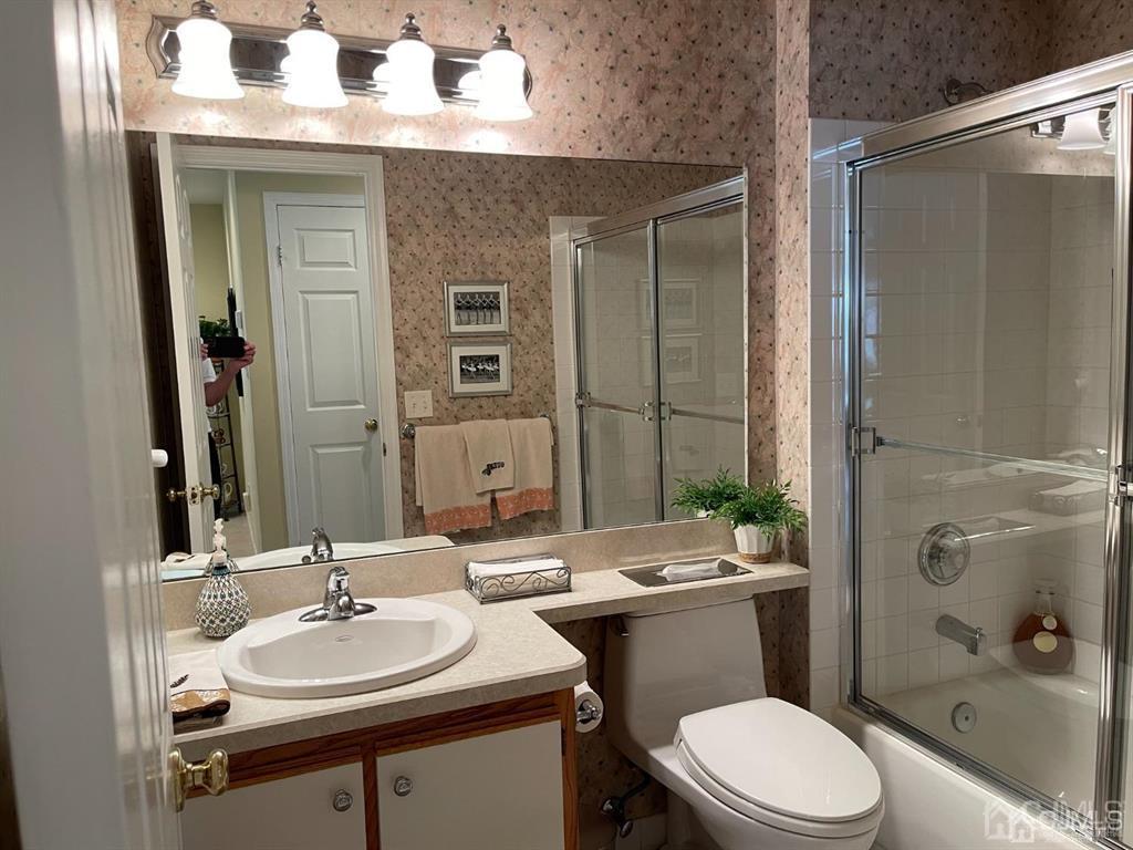 70 A Winthrop Road Monroe Township, NJ 08831 - Photo 43 of 50 a bathroom with a sink a toilet a mirror and shower