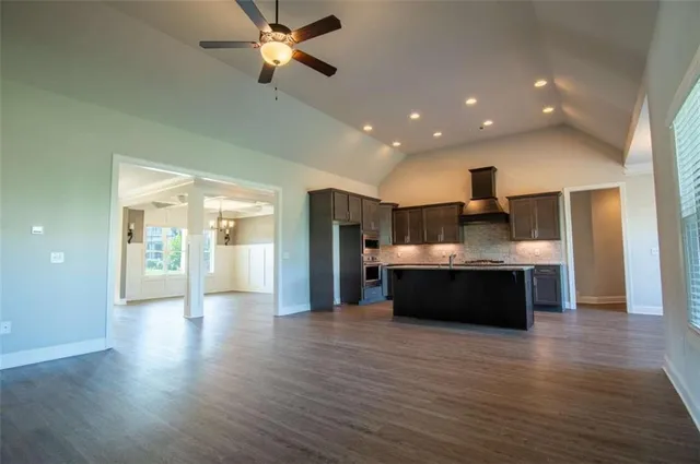 a kitchen with granite countertop a stove and a microwave