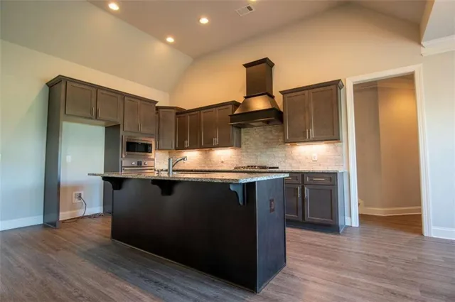 a view of kitchen with sink and wooden floor