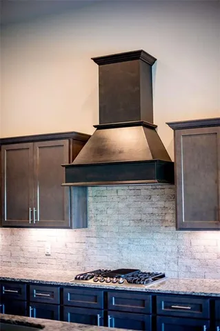 a view of a livingroom with a fireplace wooden floor and chandelier fan