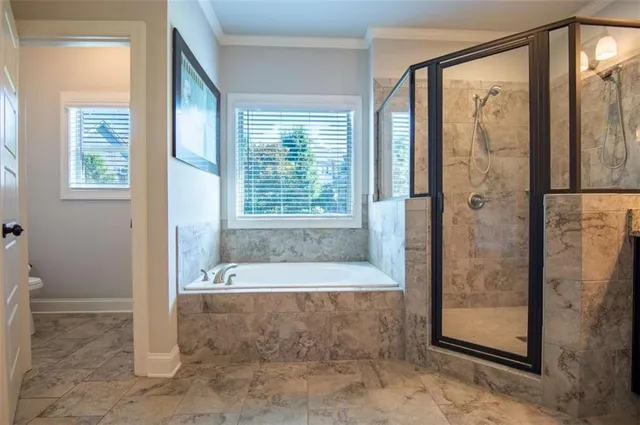 a view of a bathroom with a tub and a shower
