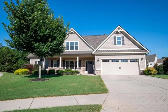 a front view of house with yard and green space