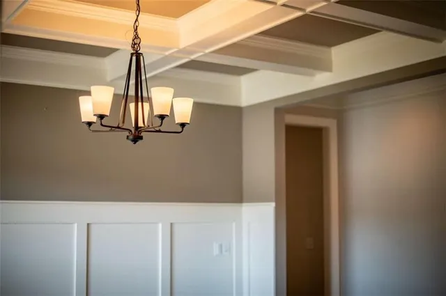 a large kitchen with stainless steel appliances a large counter top a refrigerator and a fireplace