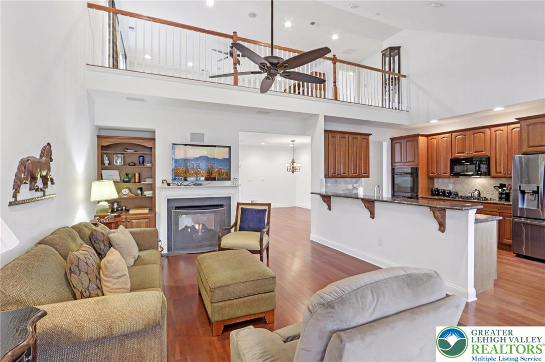 2076 Kingsview Road Lower Macungie Township, PA 18062 - Photo 12 of 53 a living room with furniture a kitchen view and a chandelier