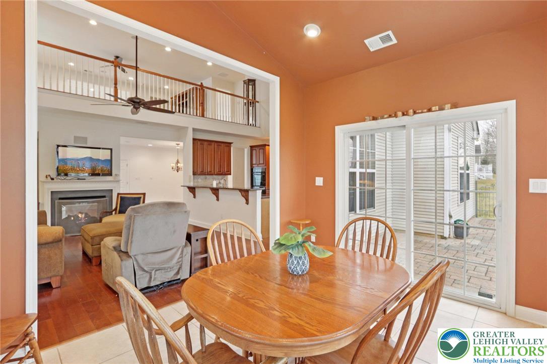 2076 Kingsview Road Lower Macungie Township, PA 18062 - Photo 16 of 53 a dining room with furniture a rug and wooden floor