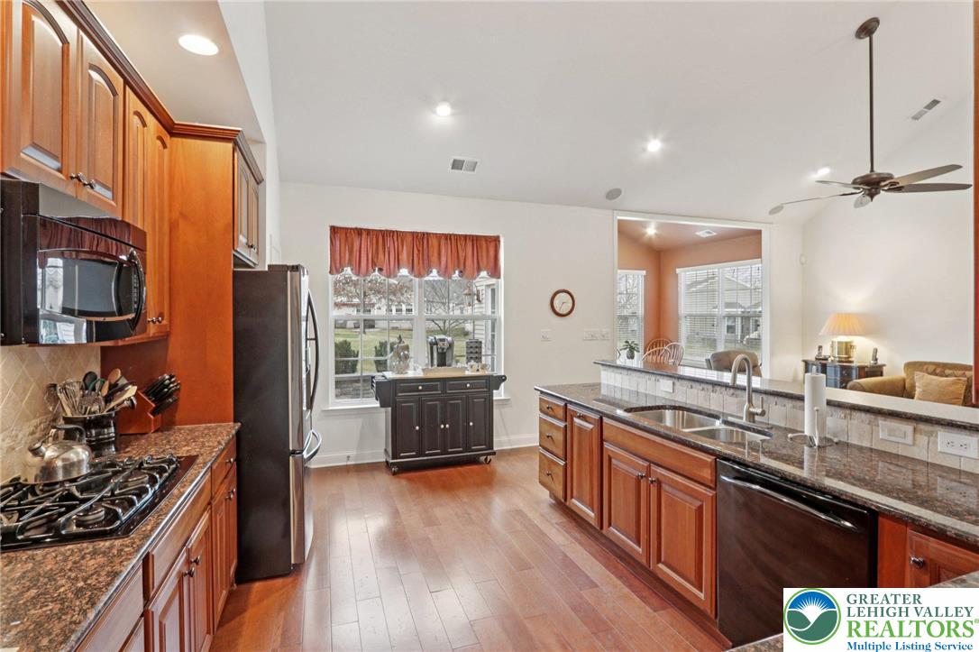 2076 Kingsview Road Lower Macungie Township, PA 18062 - Photo 23 of 53 a kitchen with stainless steel appliances granite countertop a stove a sink and a refrigerator