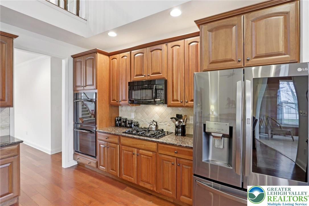 2076 Kingsview Road Lower Macungie Township, PA 18062 - Photo 24 of 53 a kitchen with stainless steel appliances granite countertop a refrigerator stove and cabinets
