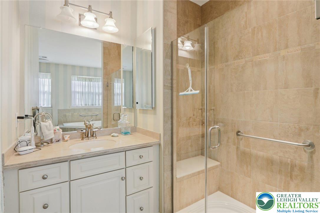 2076 Kingsview Road Lower Macungie Township, PA 18062 - Photo 27 of 53 a bathroom with a shower sink and mirror