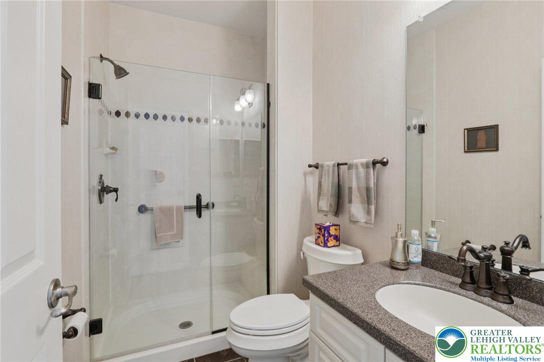 2076 Kingsview Road Lower Macungie Township, PA 18062 - Photo 30 of 53 a bathroom with a sink toilet a mirror and shower