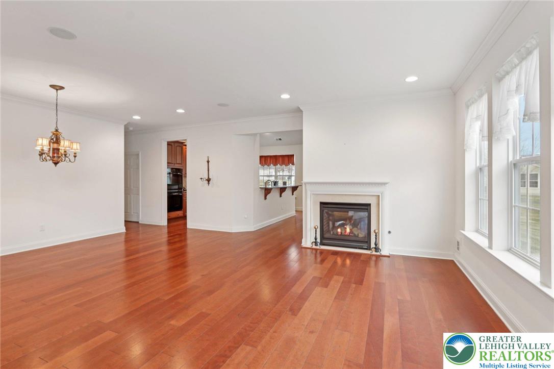 2076 Kingsview Road Lower Macungie Township, PA 18062 - Photo 3 of 53 an empty room with wooden floor fireplace and windows
