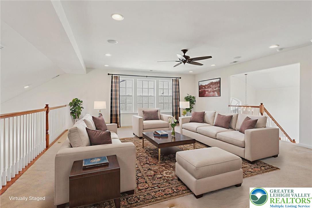 2076 Kingsview Road Lower Macungie Township, PA 18062 - Photo 34 of 53 a living room with furniture ceiling fan and a rug