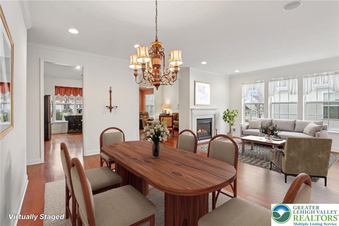 2076 Kingsview Road Lower Macungie Township, PA 18062 - Photo 6 of 53 a view of a dining room with furniture a chandelier and wooden floor
