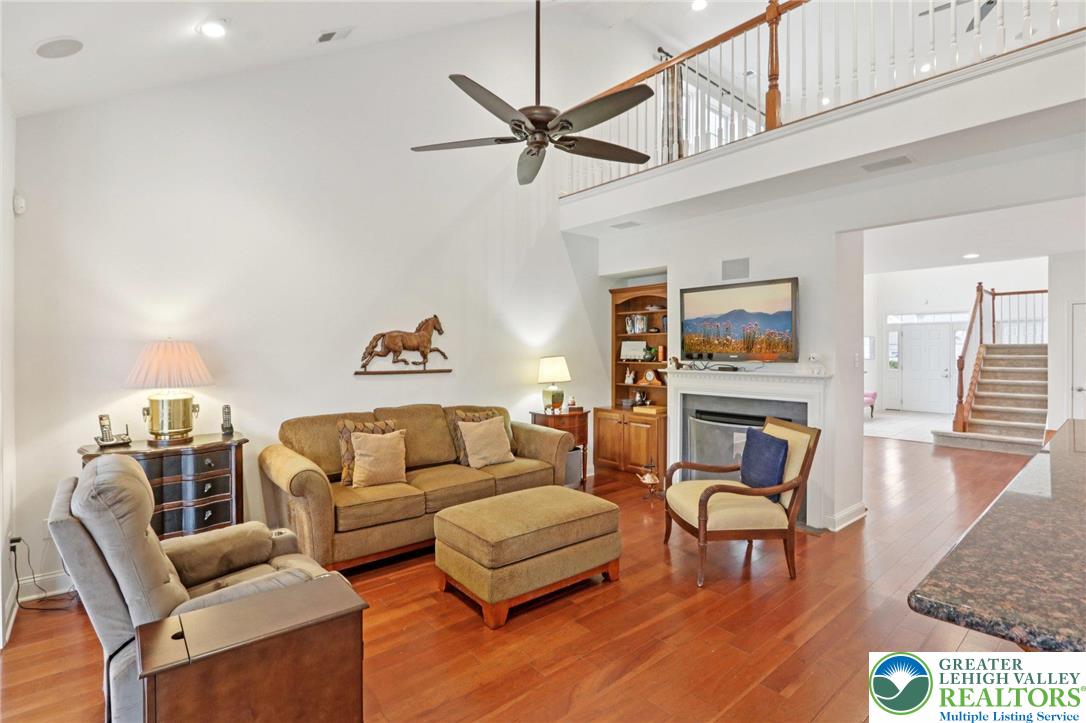 2076 Kingsview Road Lower Macungie Township, PA 18062 - Photo 9 of 53 a living room with furniture a ceiling fan and a rug