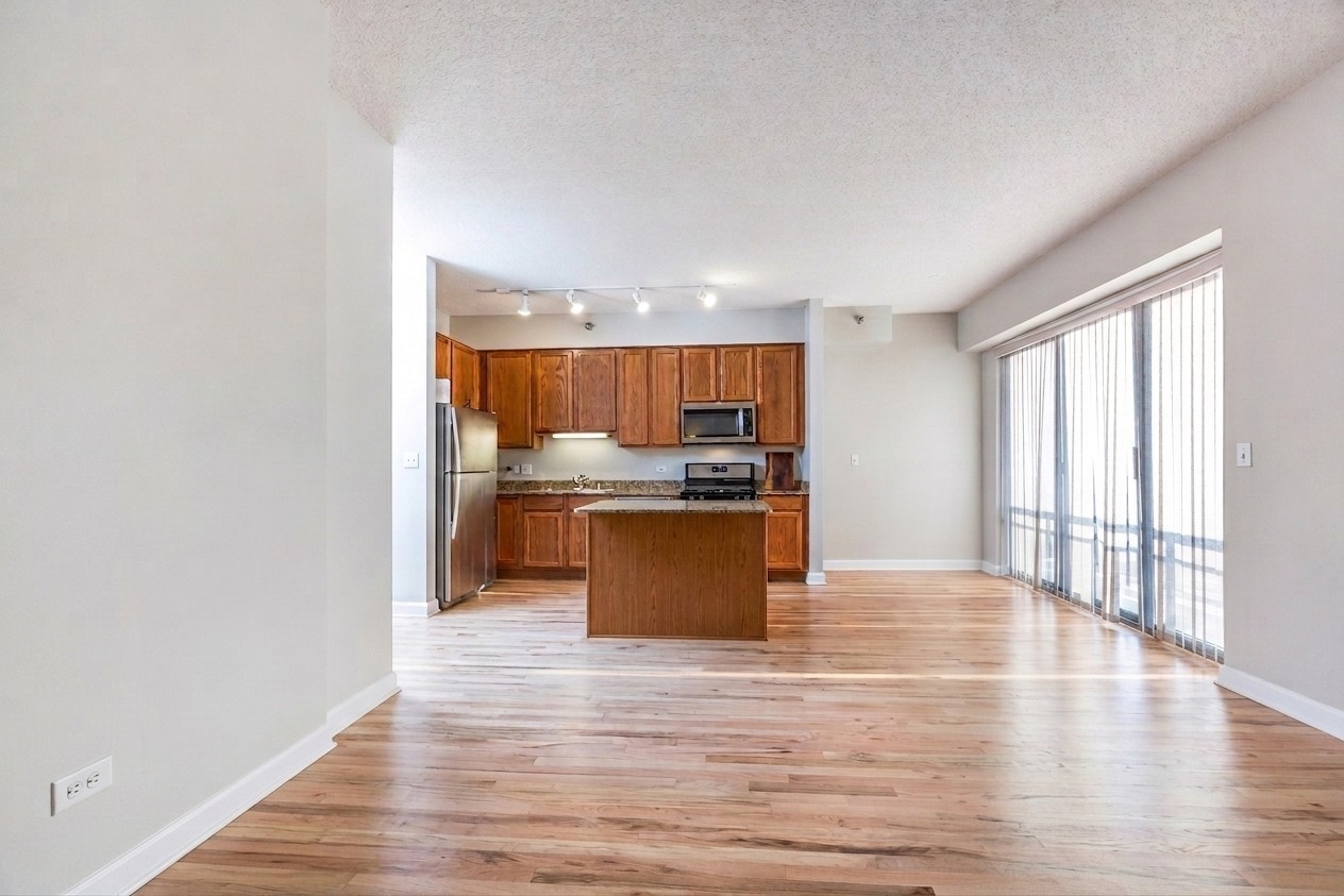41 East 8th Street, Unit 1805 Chicago, IL 60605 - Photo 14 of 33 a kitchen with stainless steel appliances granite countertop a stove top oven and sink