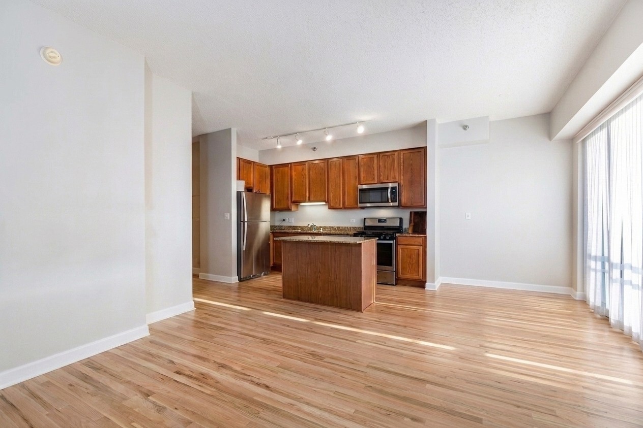 41 East 8th Street, Unit 1805 Chicago, IL 60605 - Photo 17 of 33 a kitchen with stainless steel appliances granite countertop a refrigerator and a stove top oven