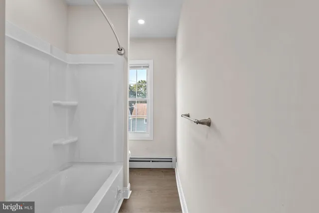 a bathroom with a tub and shower
