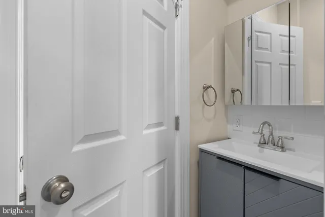 a bathroom with a sink and mirror