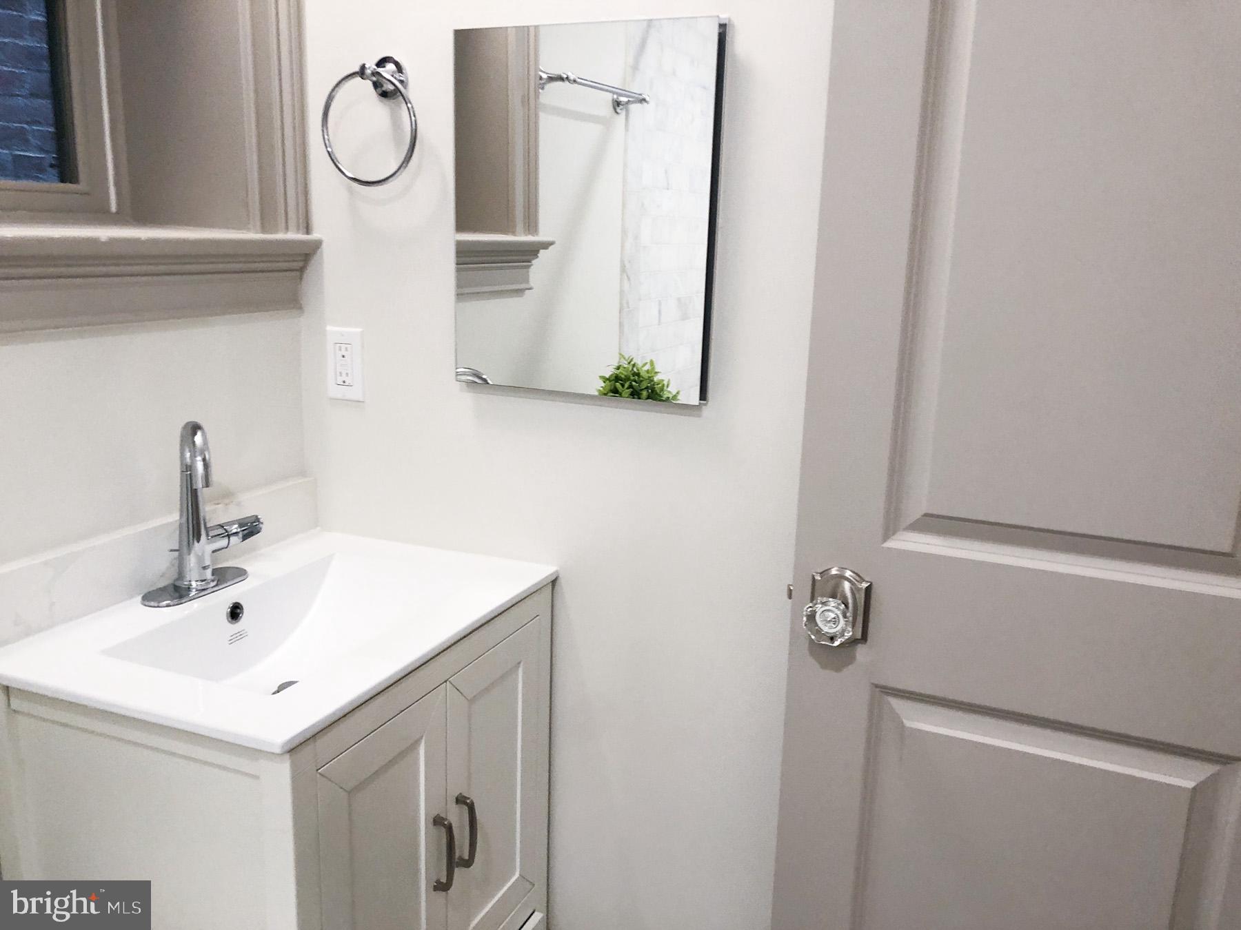 1302 East Capitol Street Northeast, Unit B Washington, DC 20003 - Photo 12 of 23 a bathroom with a sink and a mirror
