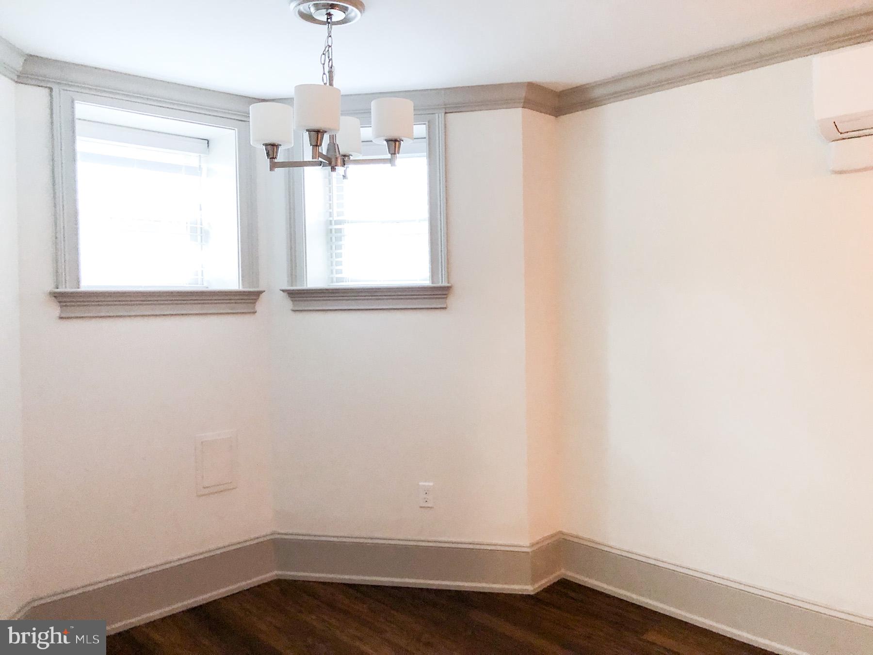 1302 East Capitol Street Northeast, Unit B Washington, DC 20003 - Photo 6 of 23 an empty room with wooden floor and windows